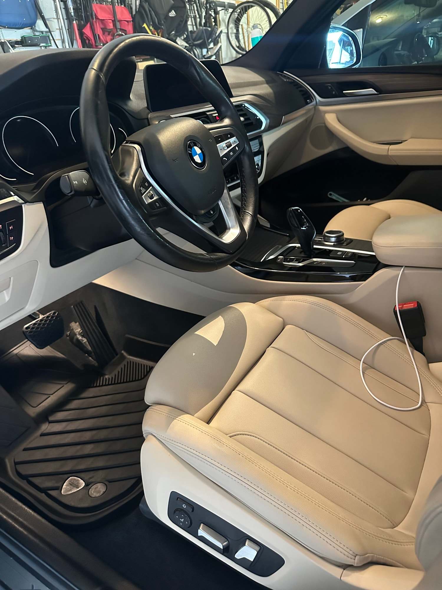 Beige leather seats and black dash inside a BMW