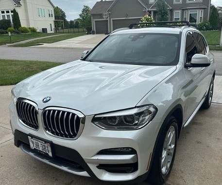 White BMW X3 parked on a residential driveway