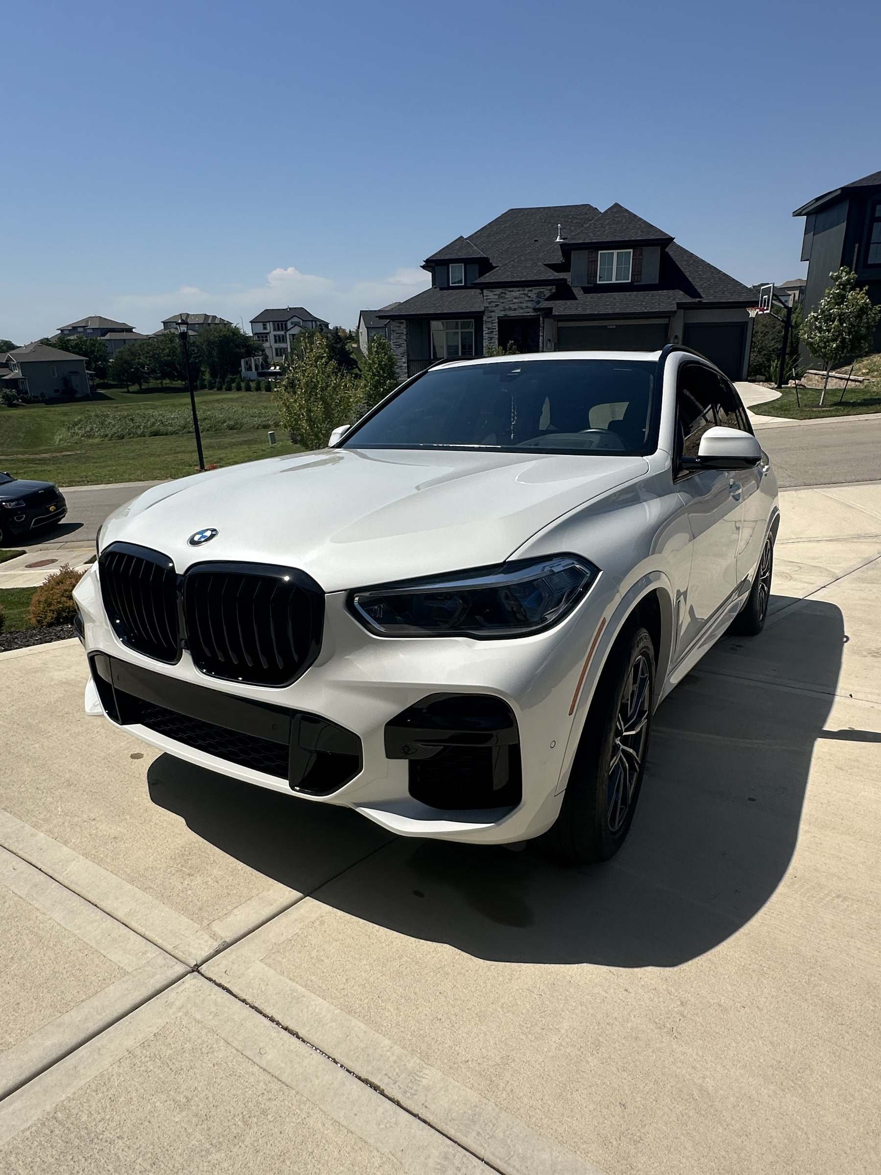 White BMW X5 parked on a driveway after a Takumi detail