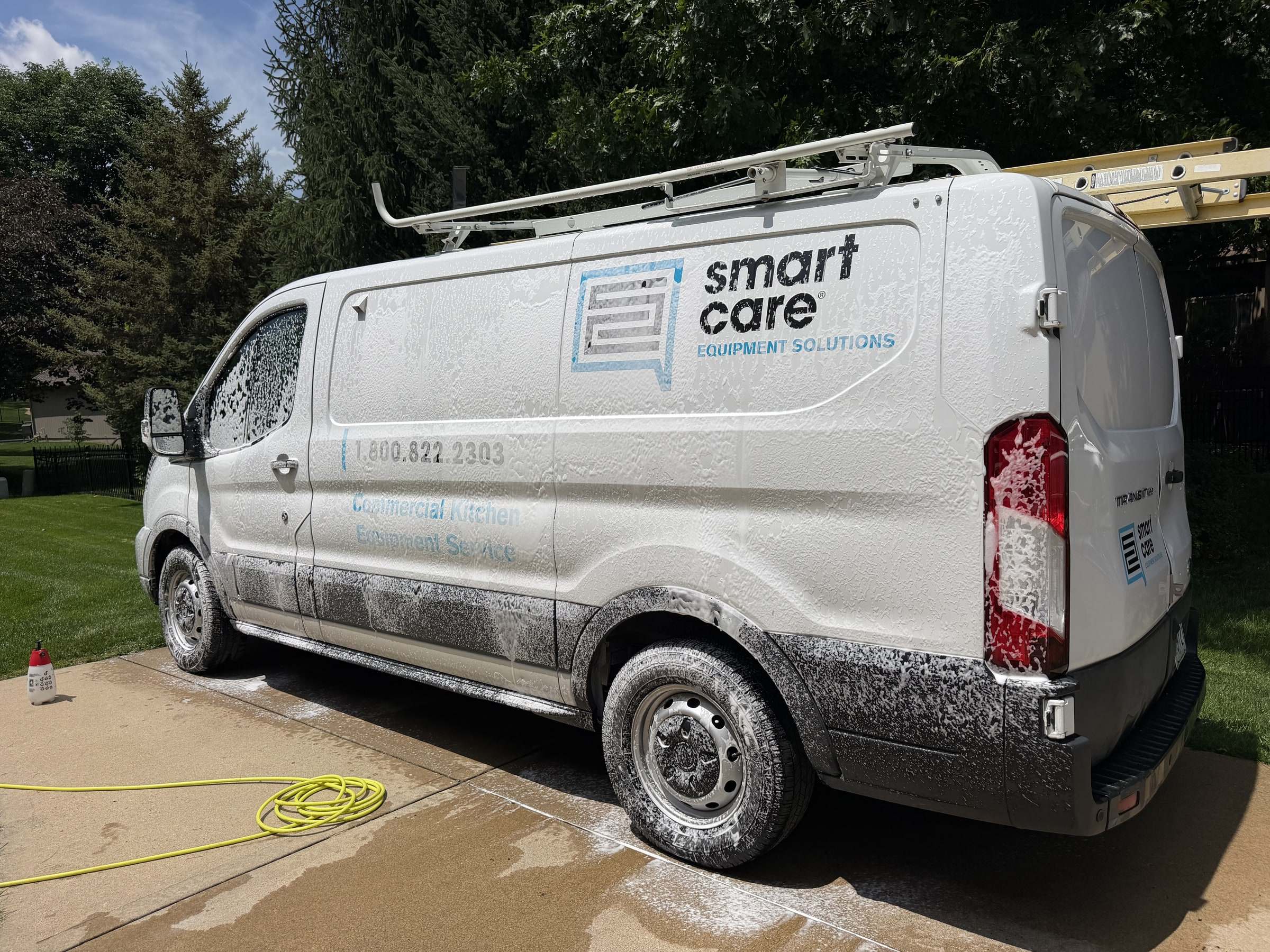 White commercial fleet van on a driveway after a Takumi mobile detail