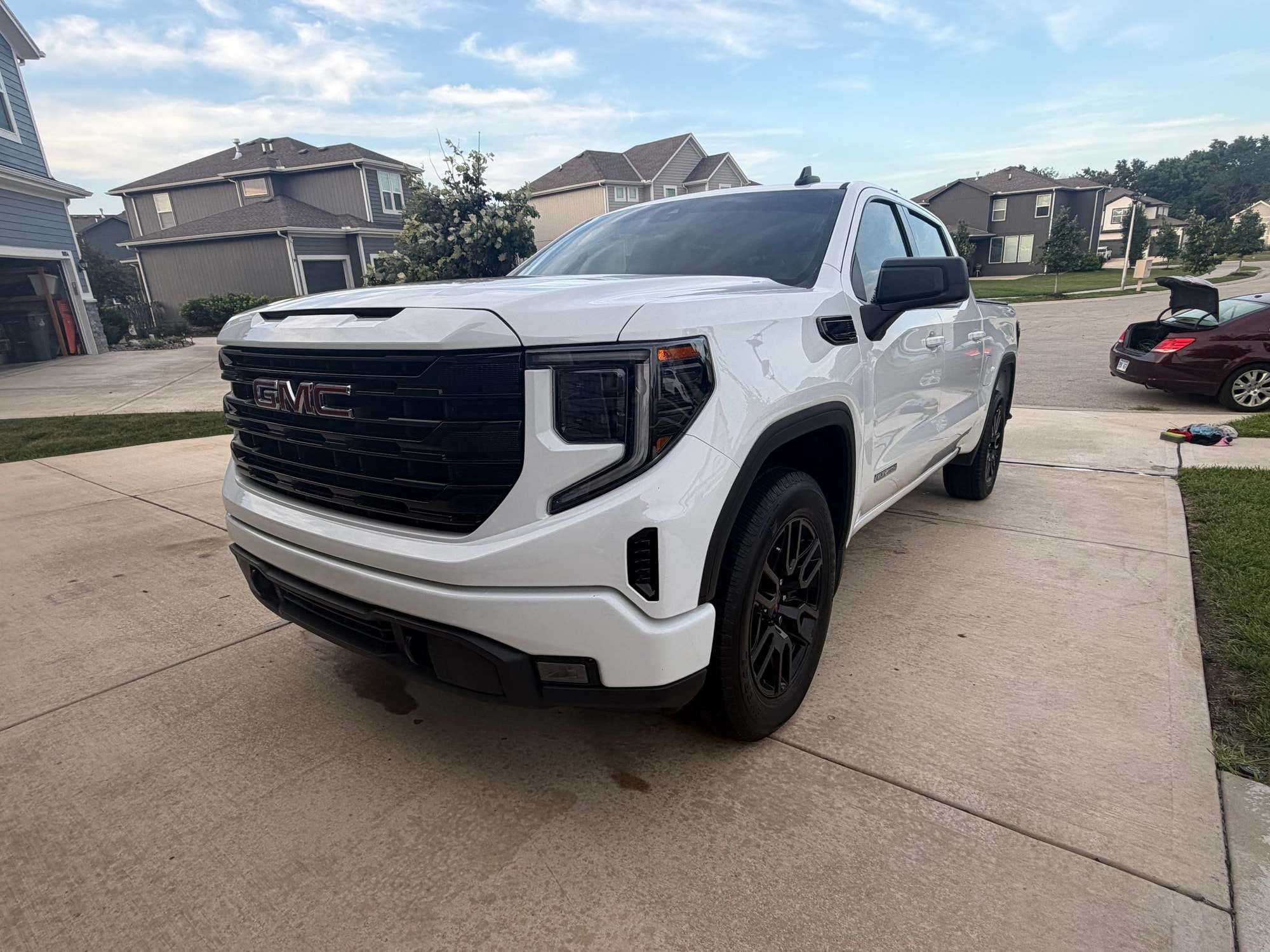 White GMC pickup on a suburban driveway
