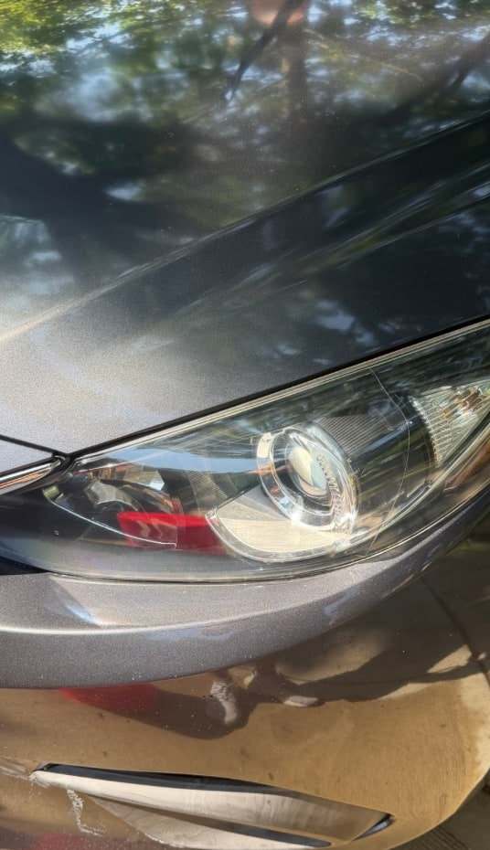 Clear, restored headlight on a gray Hyundai after Takumi headlight restoration