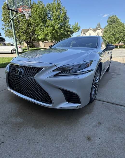 Silver Lexus LS 500, front three-quarter view on a driveway