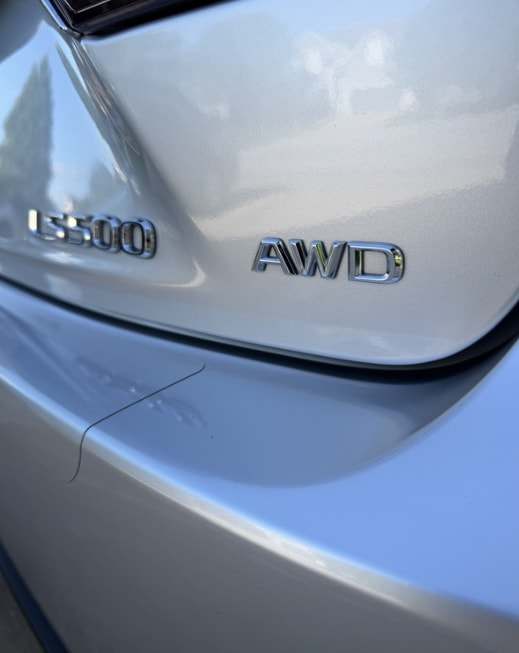 Close-up of the LS 500 AWD badges on clean silver paint