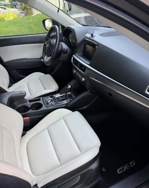 Passenger side of a Mazda CX-5 interior with white leather seats