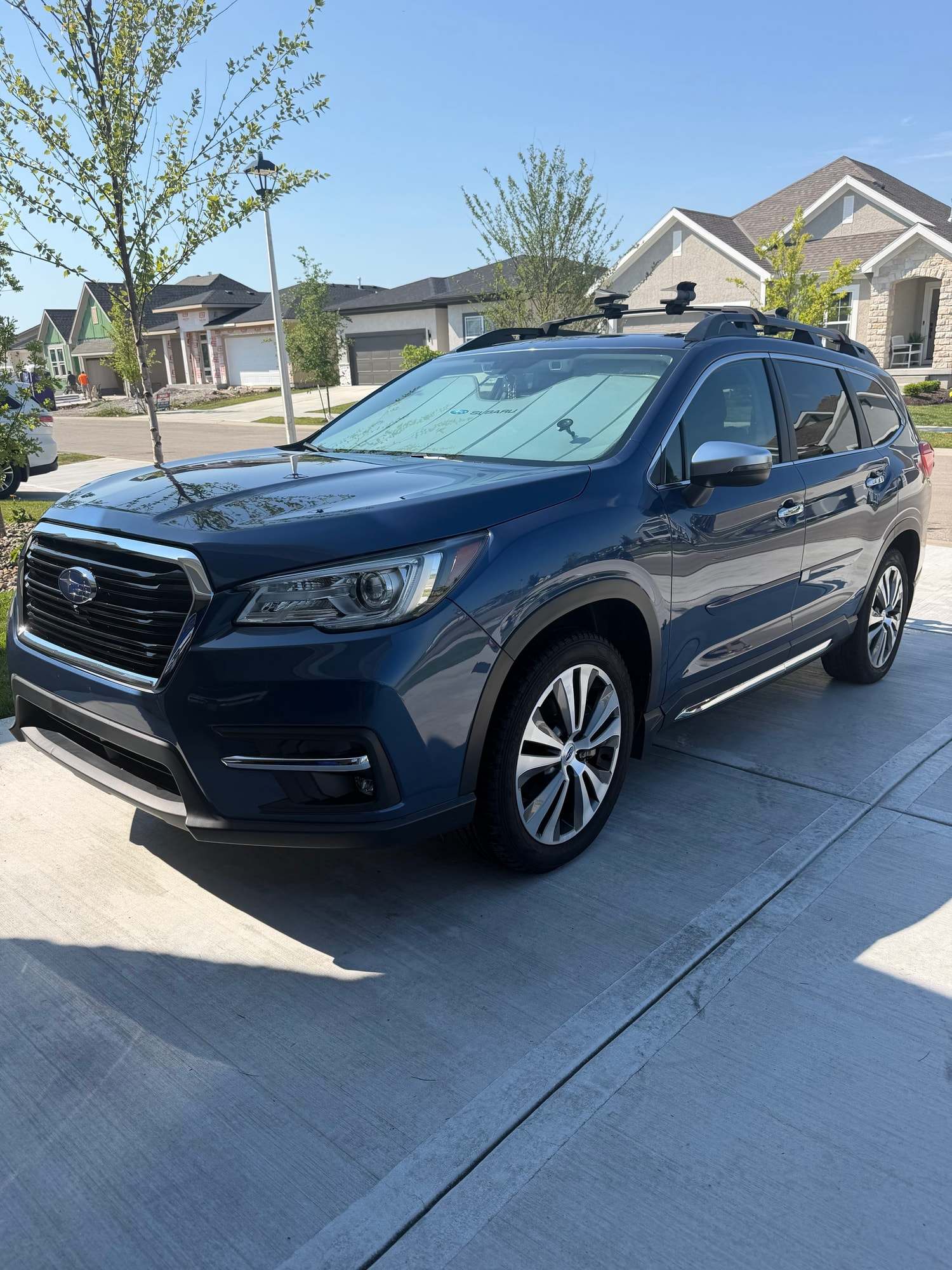 Dark blue Subaru SUV on a sunny driveway