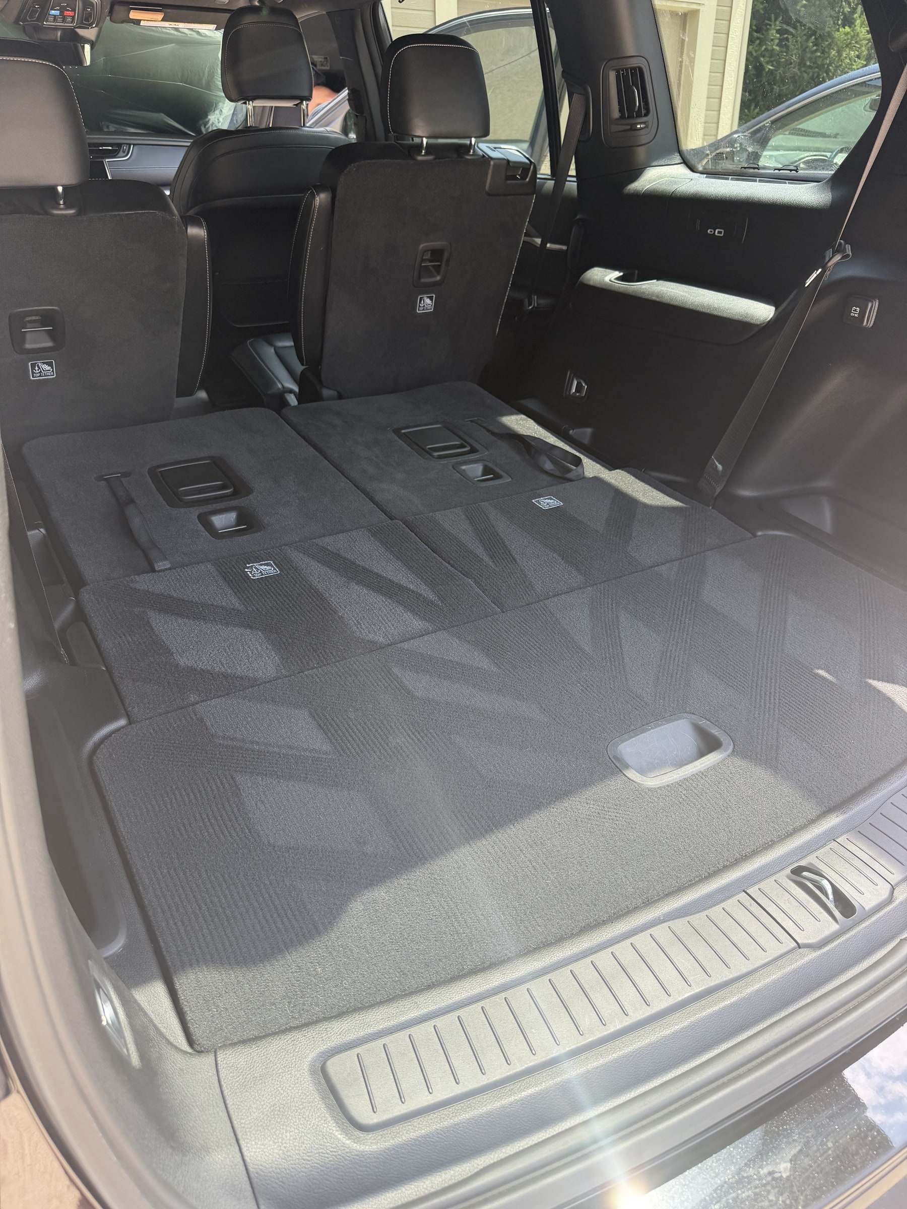 Clean cargo area of an SUV with the third row folded flat