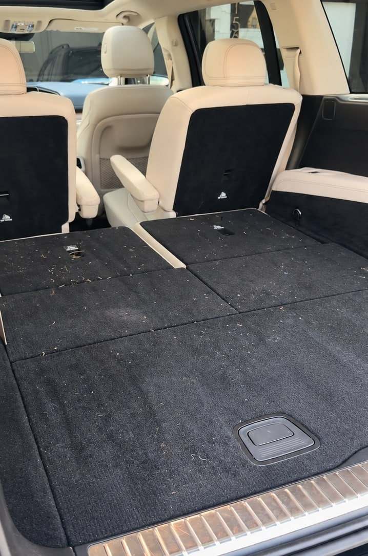 SUV cargo area with the third row folded, before the detail