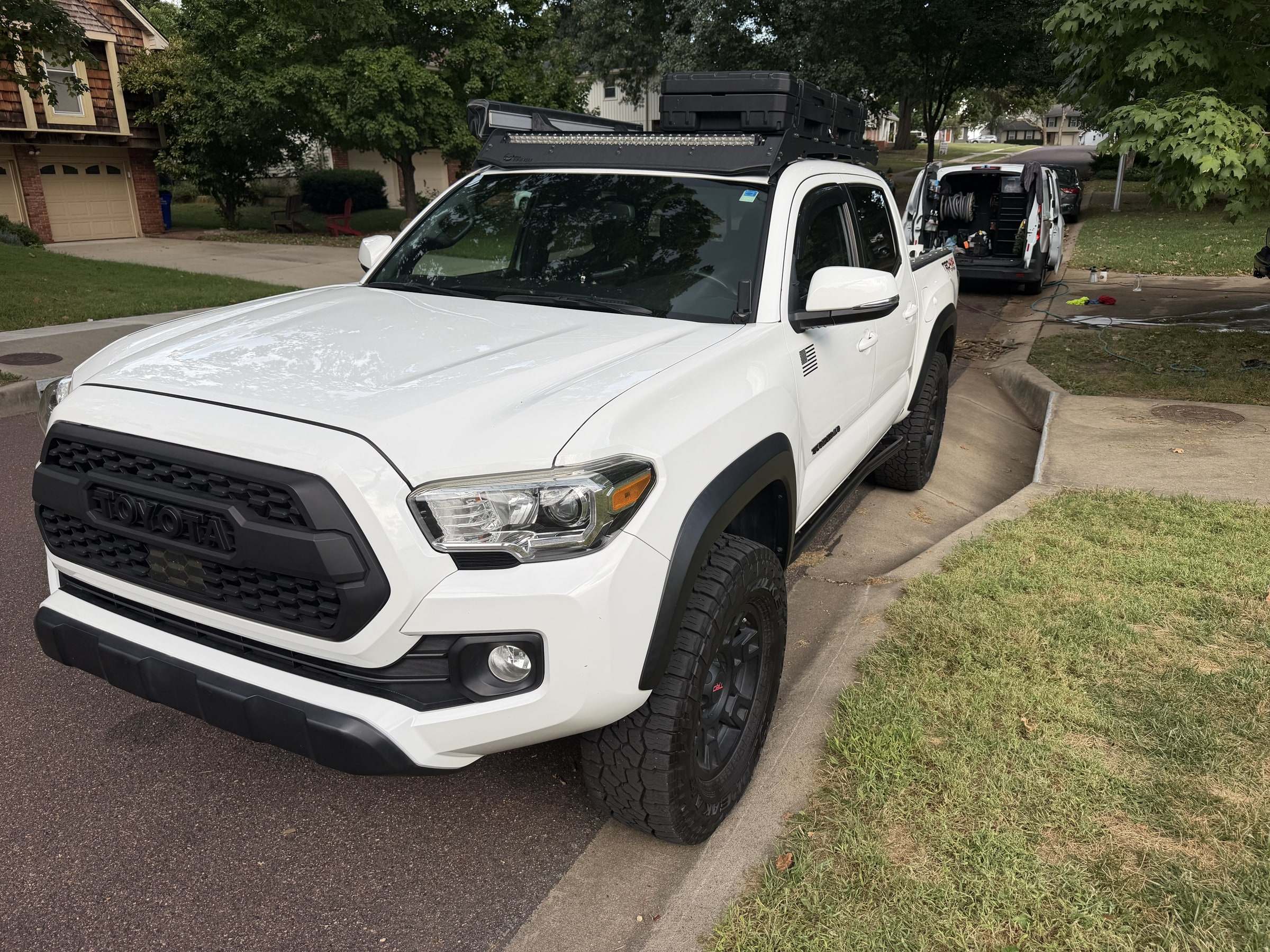 White Toyota Tacoma pickup on a residential driveway after a Takumi detail