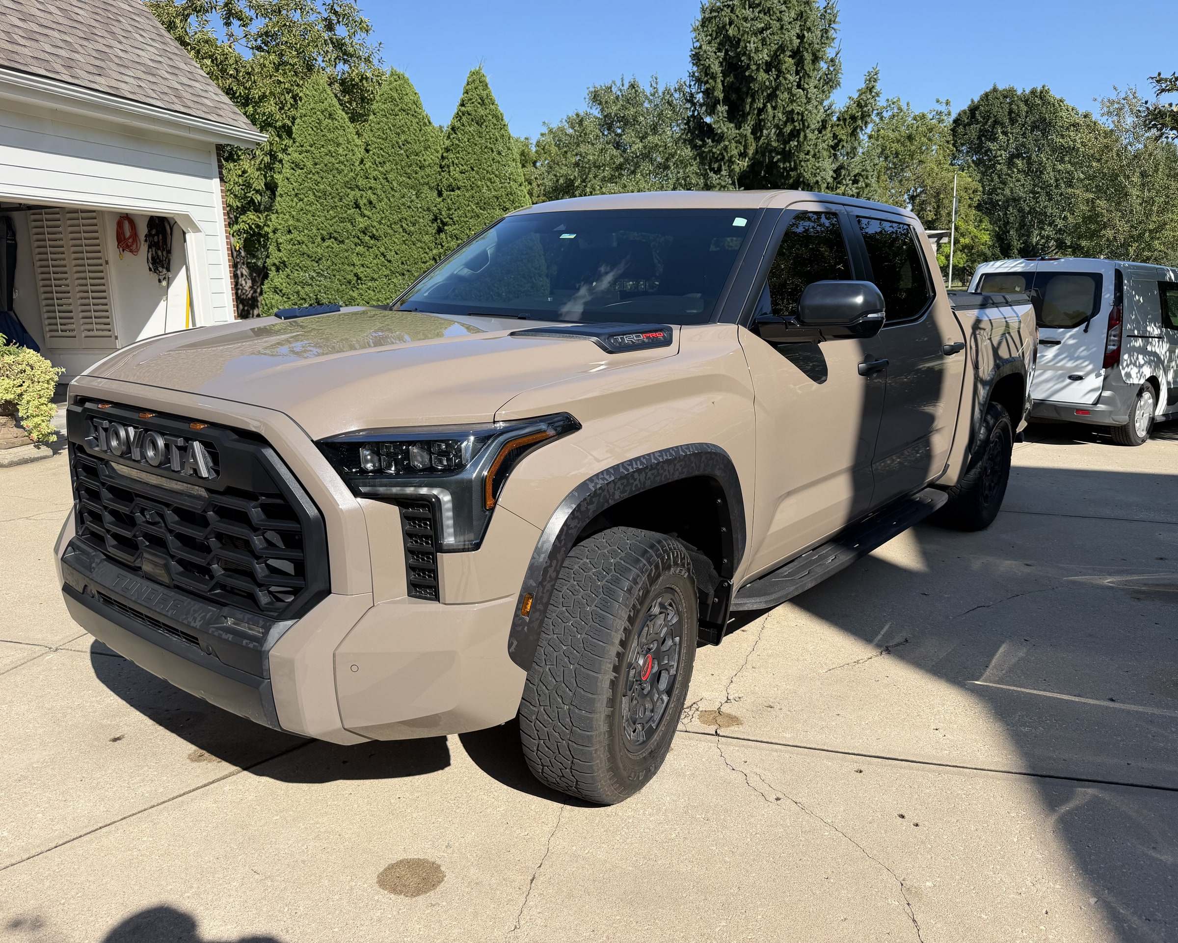 Tan Toyota Tundra pickup on a driveway after a Takumi detail