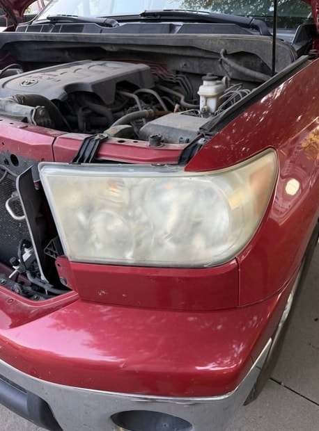 Second angle of the red Tundra with a cloudy headlight before restoration
